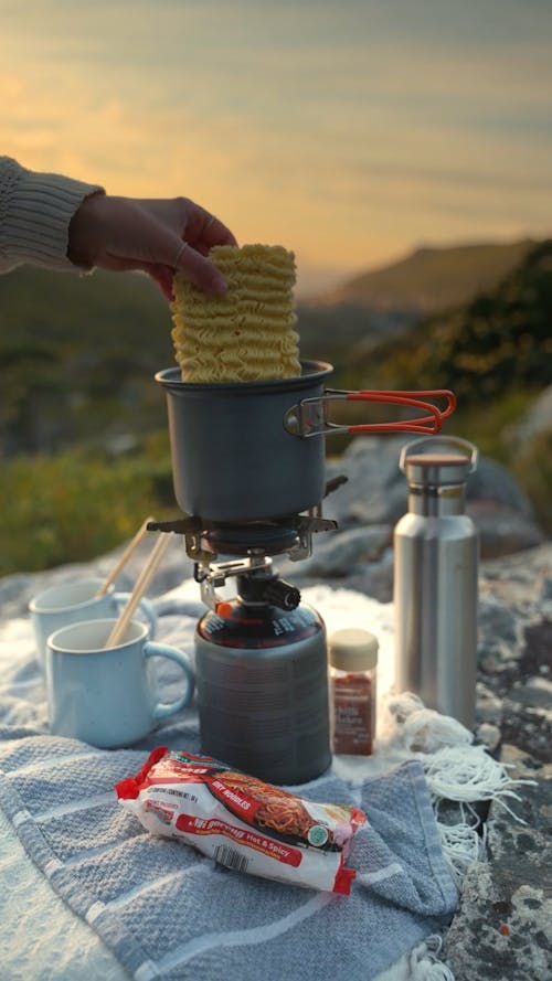 Person Cooking on a Backpacking Stove