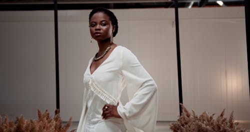 A Woman Posing in a White Dress