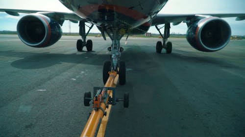 Airplane Being Towed on Airport Taxiway