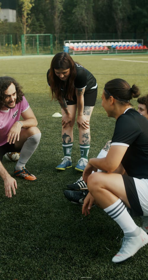 A Team of Football Players Listening to their Coach