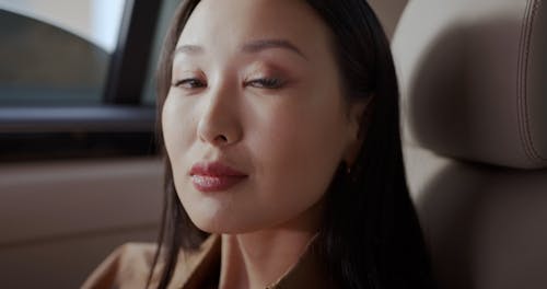 Close up of a Woman in the Back Seat of a Moving Car