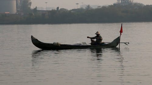 A Man Sitting on a Fishing Boat