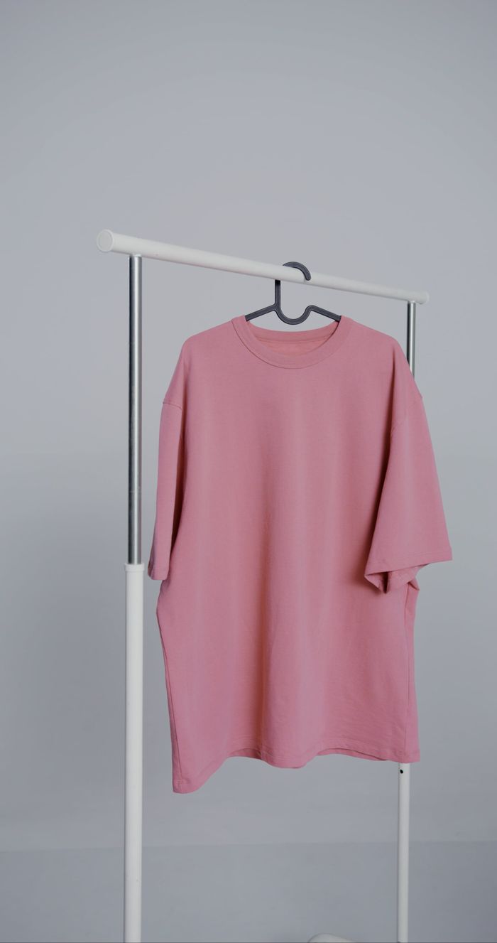 Dusty rose tee on a minimal rack
