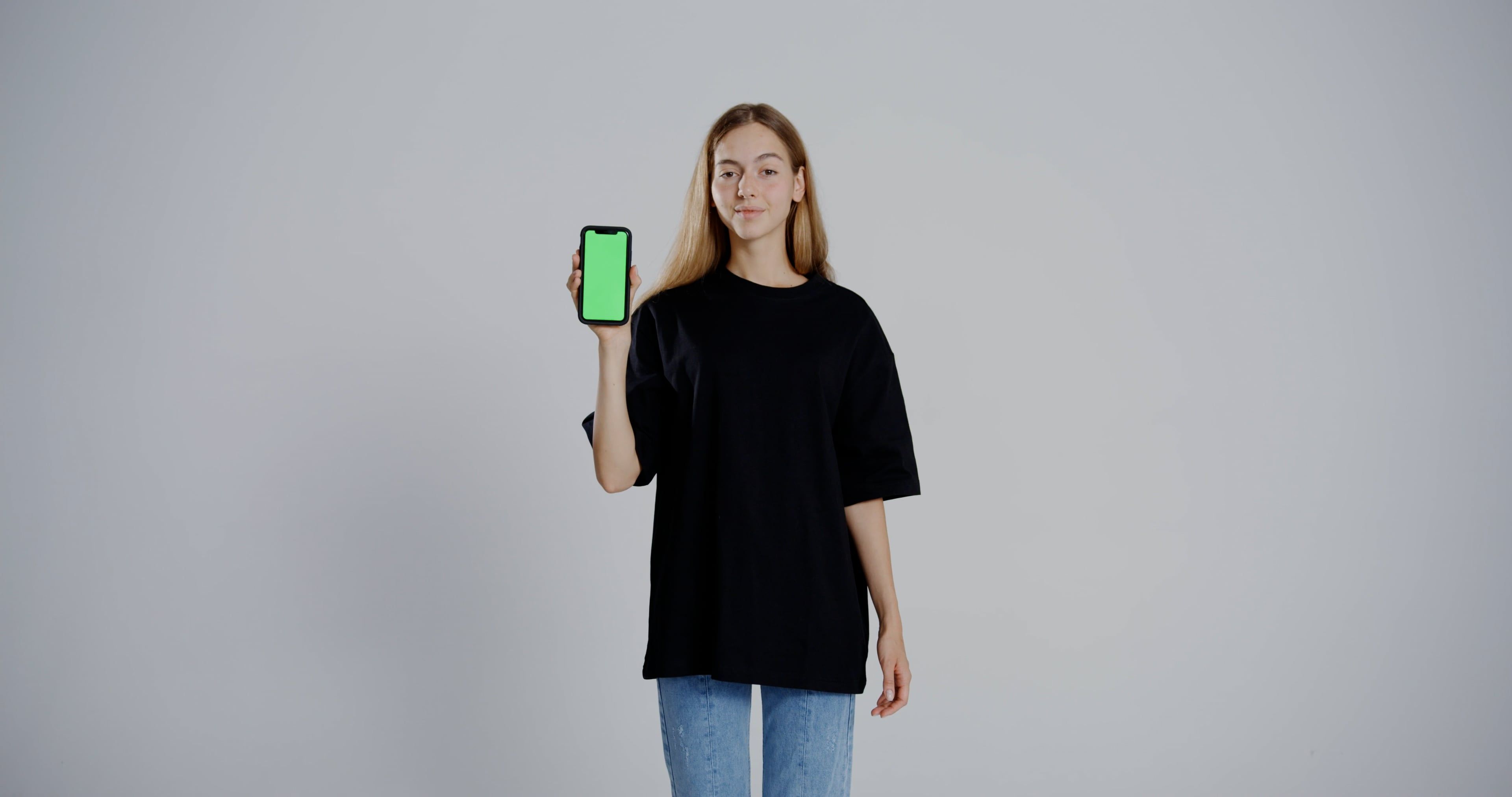 a woman in black shirt holding up a phone 9558949 — free pexels stock footage
