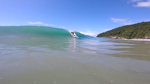 A Man Surfing on the Beach