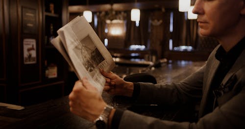 An Elderly Man Reading Newspaper