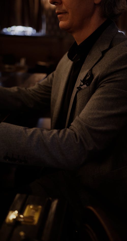 A Man Putting His Money on a Bar Counter