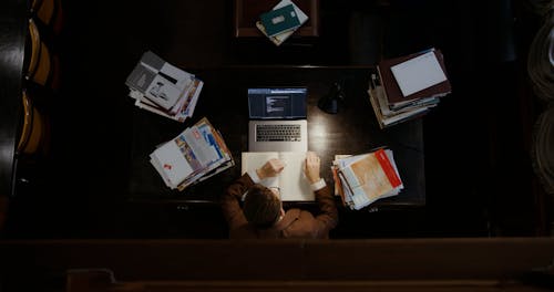 A Person Typing using a Laptop