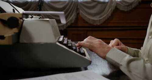 A Person Using a Vintage Typewriter