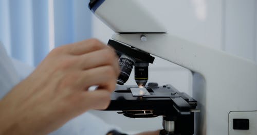 Close Up Shot of Man Looking at the Microscope 