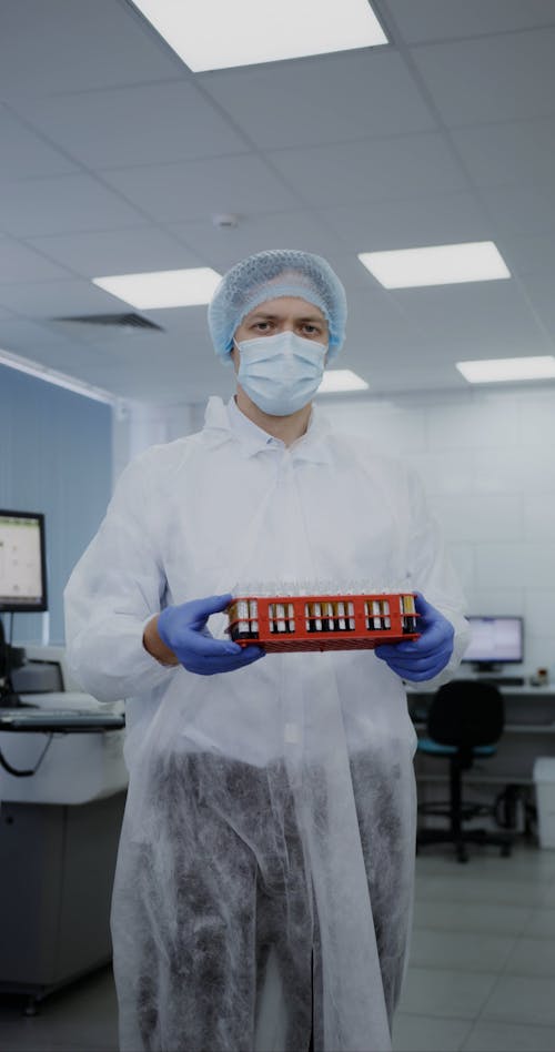 Man Holding Laboratory Equipment While Looking Camera 