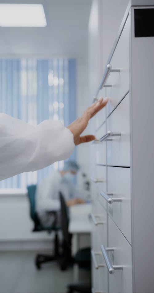 A Scientist Getting a Microscope Slide from a Drawer