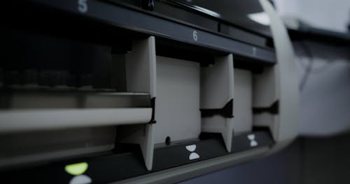 Close up of a Person Inserting a Specimen Tray into an Immunoassay Analyzer