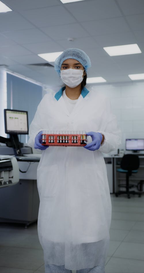 A Woman Wearing a Gloves while Holding Samples