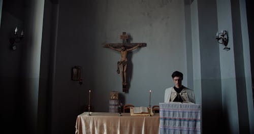 Man Reading a Book at the Altar
