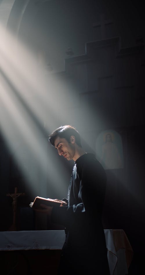 Man Reading a Bible at the Church