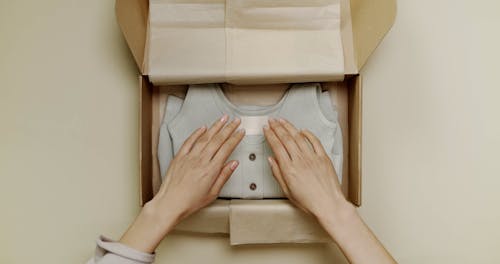 Person Packing a Product on a Box