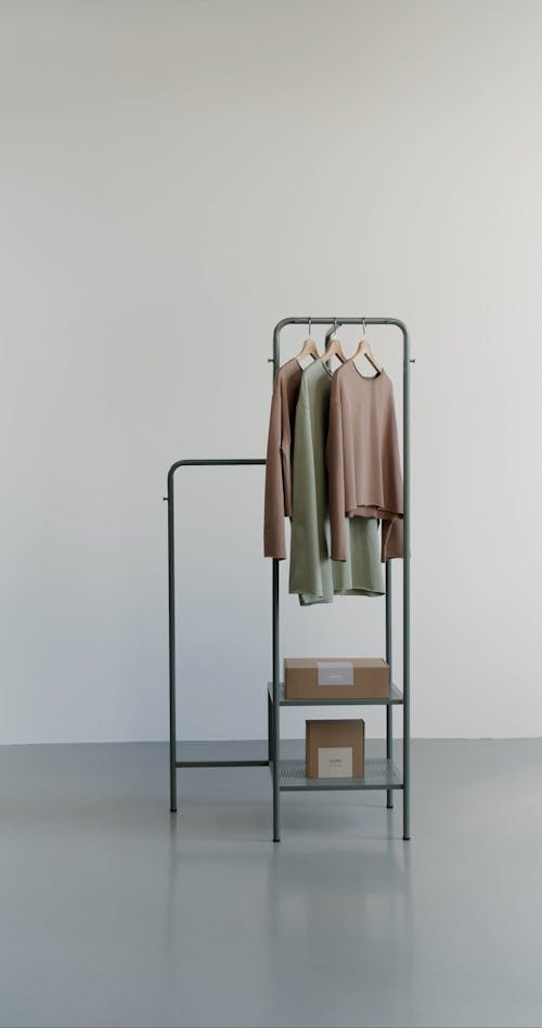 A Woman Putting Clothes on a Rack
