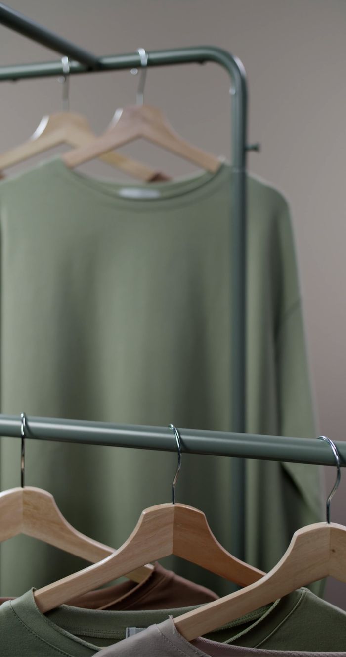 Sage tops being arranged on a rack