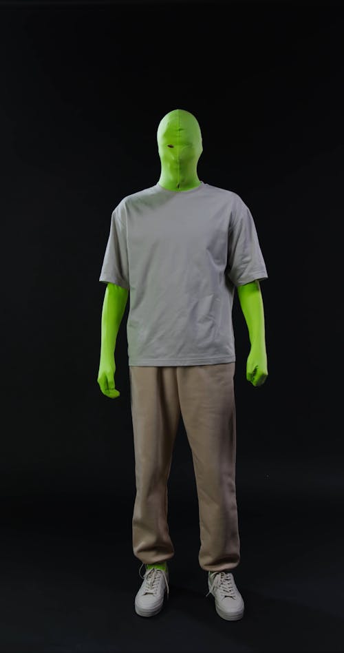 A Person in a Green Screen Suit Jumping
