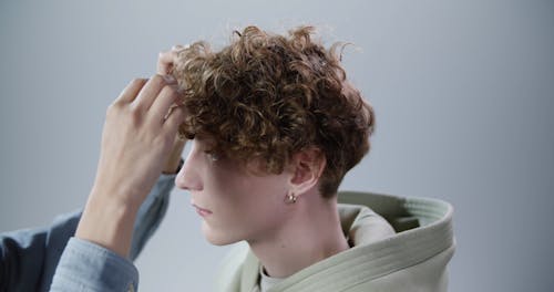 A Male Model Preparing for a Photo Session