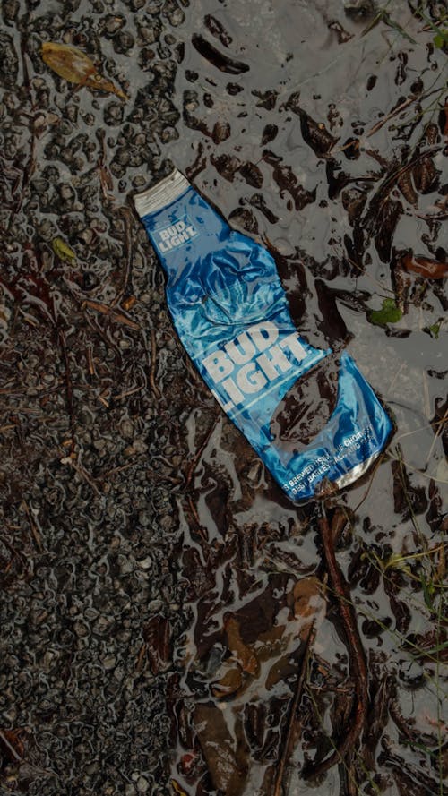 Close-up of rain falling on plastic bottle