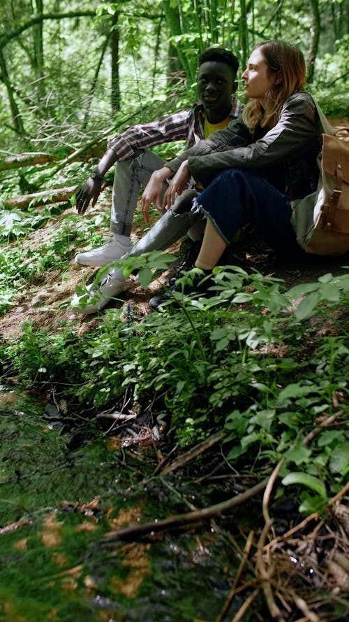 People Sitting on the Ground While Having a Conversation