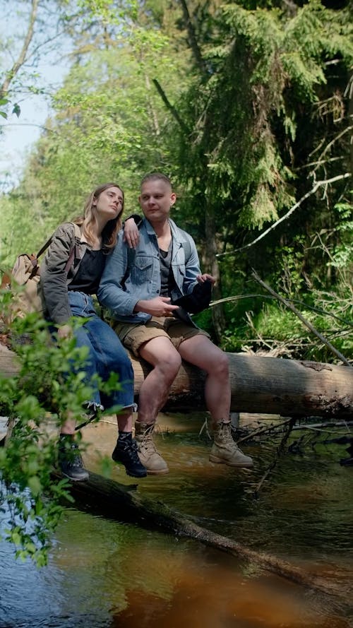 Couple Sitting on a Tree Trunk