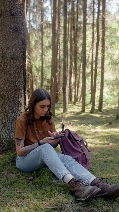 A Woman Sitting Near the tree