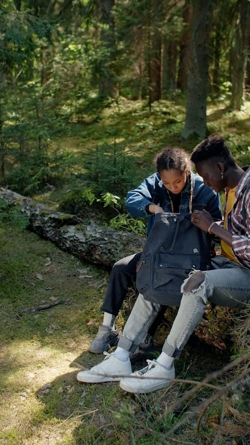 Man and Woman Sitting on the Wood Log