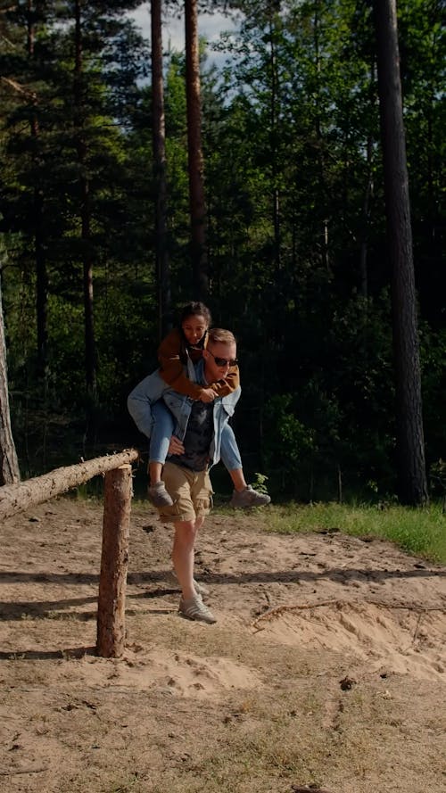 Man and Woman Walking on the Sand