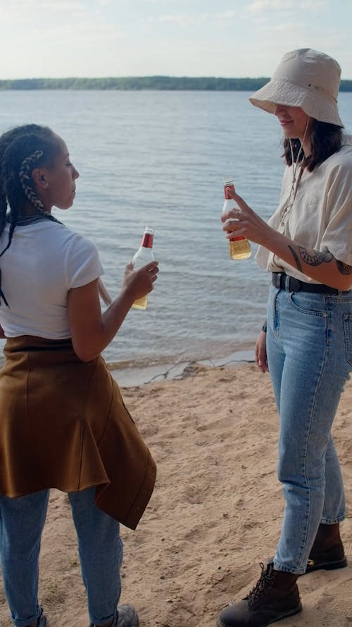 Women Having a Cheers while in the Beach