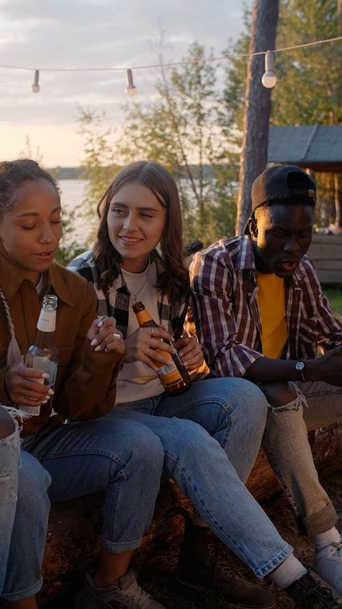 People Dancing While Holding Bottles