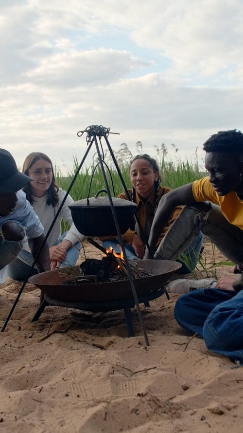 People Cooking Using a Burning Woods