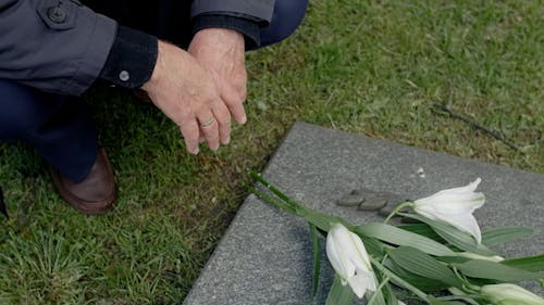 Close-up Footage of a Person Touching the Tombstone