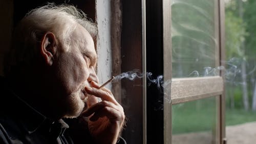 Sad Man Smoking a Cigarette