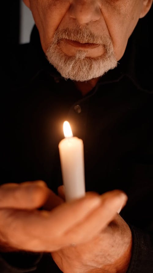 Close Up Video of Man Holding a Candle