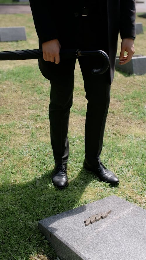 Man Holding a Grave in a Cemetery