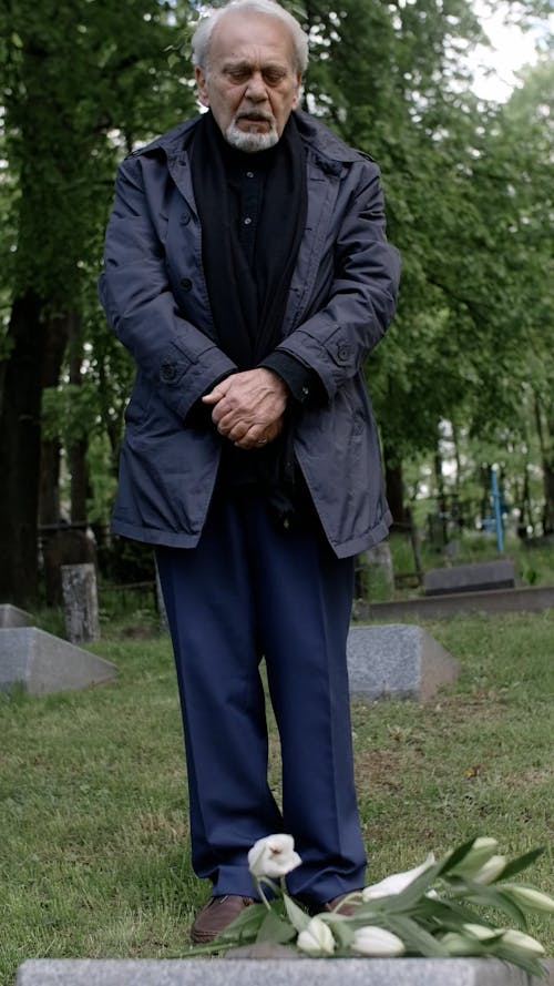 Elderly Man Crying at the Cemetery