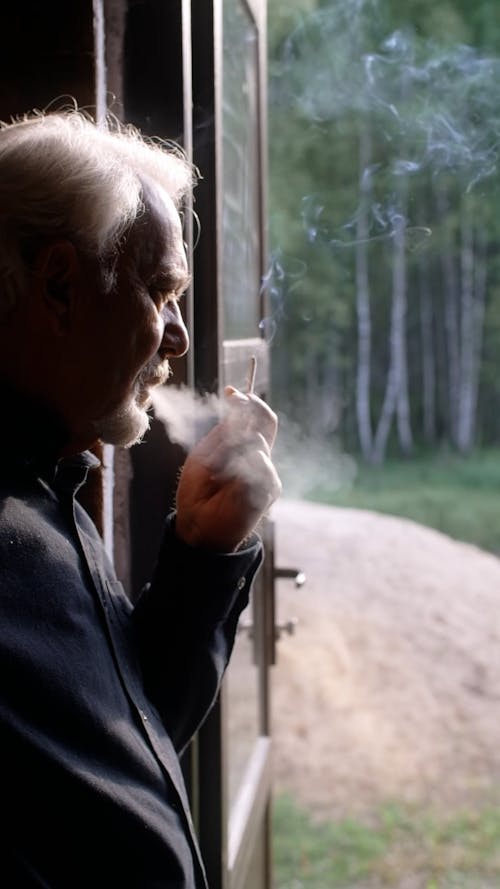 An Elderly Man Smoking Cigarette