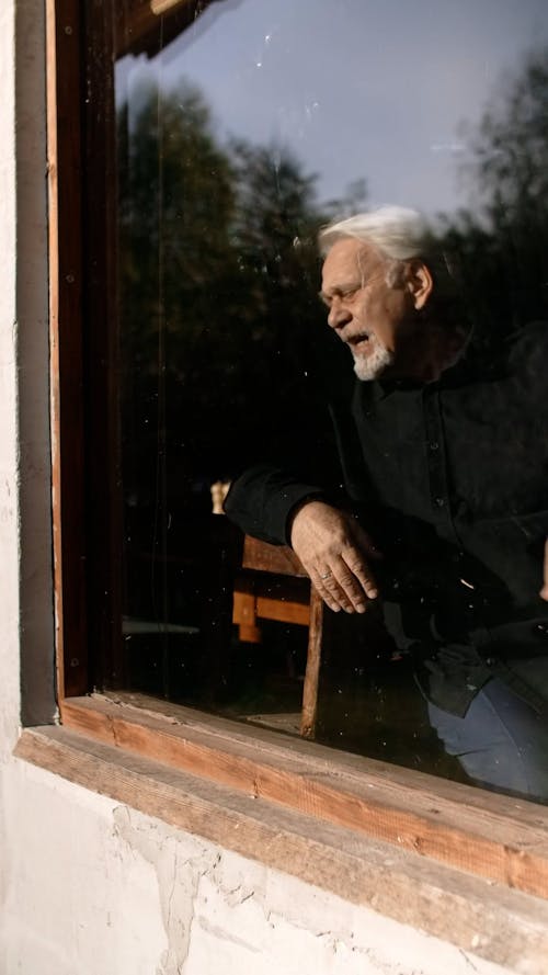 An Elderly Man Wiping His Tears