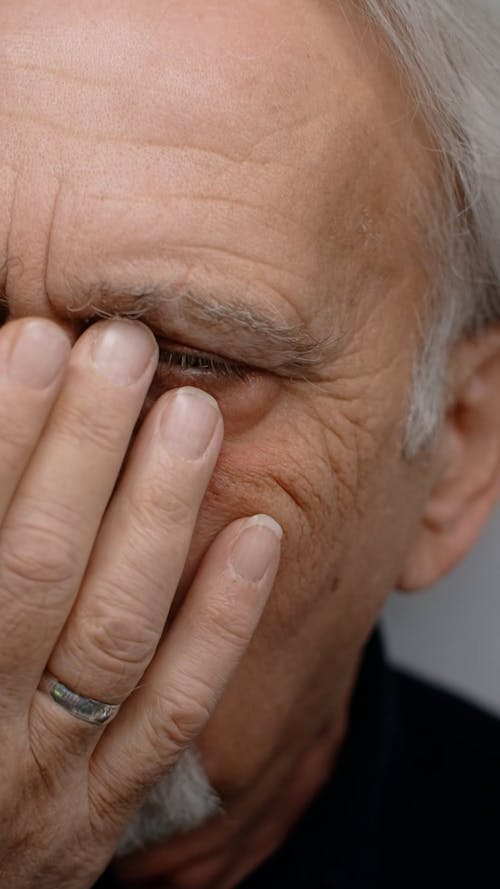 Man Holding his Eye 