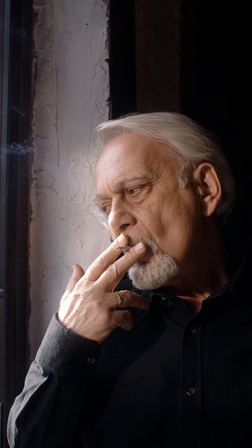 An Elderly Man Smoking 