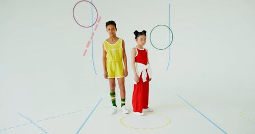 Two children posing against white background