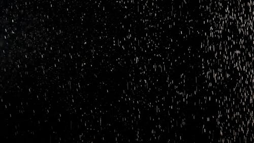 Falling Tiny White Dust Particles on Black Background