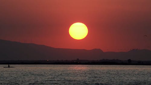 Time lapse of sun setting above lake