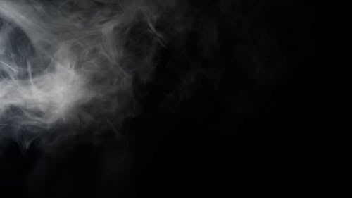 Footage of smoke against black background