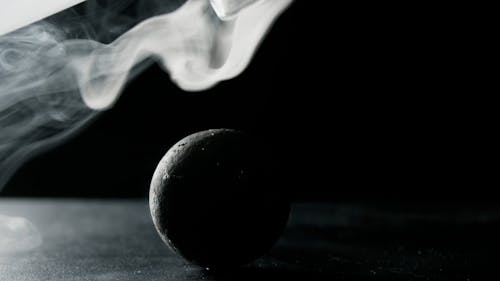 A Black Ball Surrounded by Smoke