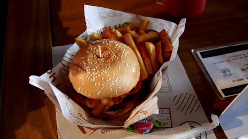Hamburger and fries on restaurant table