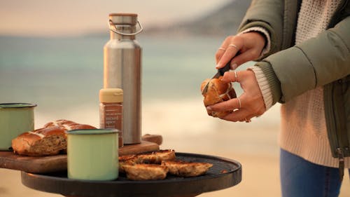 Close up of a Person Toasting Bread on a Portable Stove